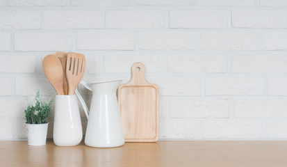 Fototapeta na wymiar Kitchen utensils and dishware on wooden shelf. Kitchen interior background.Text space.