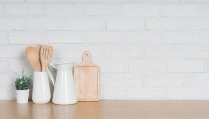 Kitchen utensils and dishware on wooden shelf. Kitchen interior background.Text space.