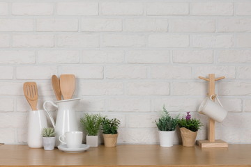 Kitchen utensils and dishware on wooden shelf. Kitchen interior background.Text space.