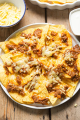 Chilli beef nachos with sour cream & grated cheese