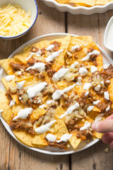 Chilli beef nachos with sour cream & grated cheese