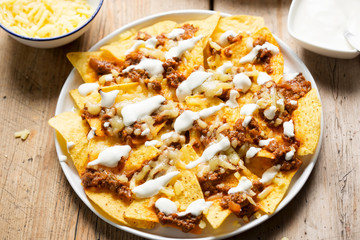 Chilli beef nachos with sour cream & grated cheese