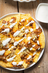 Chilli beef nachos with sour cream & grated cheese