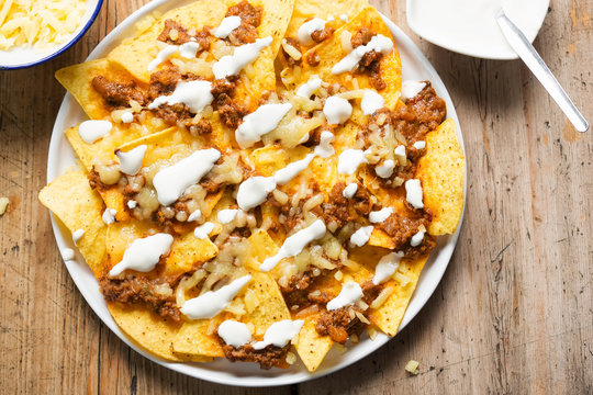 Chilli beef nachos with sour cream & grated cheese