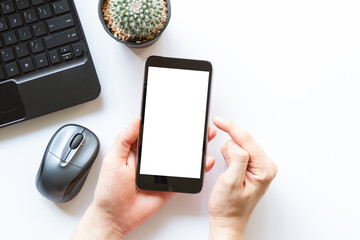 white office table with office supplies and mobile phone with blank white screen