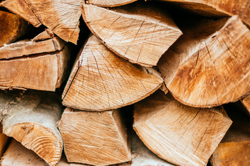 Stacked logs for firetexture, natural wooden background of firewood.