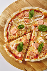 Hot Seafood Pizza on Wooden Plate Isolated