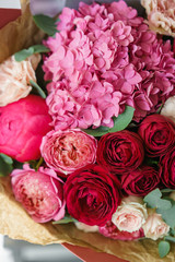 beautiful spring bouquet. flower arrangement with hydrangea and peonies. Color red and pink. The concept of a flower shop, a small family business