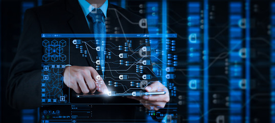 businessman hand using tablet computer and server room