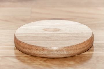 Empty wooden plate with the soft wood background.