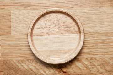 Empty wooden plate with the soft wood background.