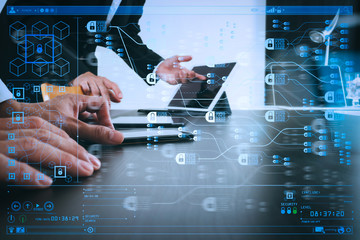 co working team meeting concept,businessman using smart phone and digital tablet and laptop computer in modern office with glass reflected view