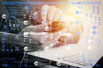 close up of businessman working with mobile phone and stylus pen and laptop computer on wooden desk...