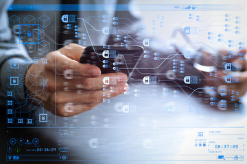 close up of businessman working with mobile phone and eyeglass on wooden desk in modern office