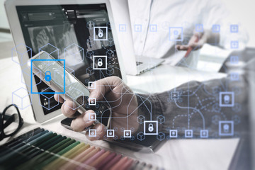 two colleague web designer discussing data and digital tablet and computer laptop with smart phone and design diagram on marble desk as concept