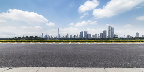 Fototapeta premium Panoramic skyline and modern business office buildings with empty road,empty concrete square floor