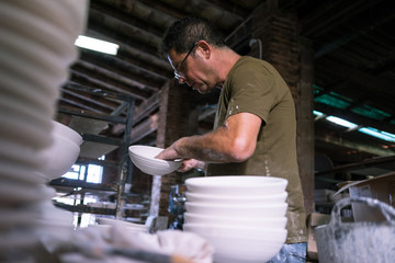 Ceramic dishes in working process. Creating ceramic pieces. Tradicional ceramic factory in spain