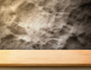 wooden plank table top at blurred rough stone wall,Template mock up for display or montage of product.