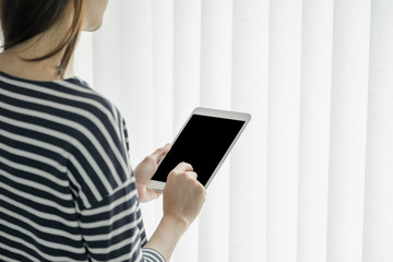 asian business owner wear casual cloth using tablet in home office working space for contact customer on online channel,office lifestyle with technology.clipping path screen.