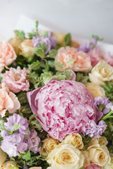 Beautiful spring bouquet. Arrangement with mix flowers. The concept of a flower shop, a small family business. Color light pink and lilac.