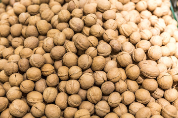 Walnuts background. Walnuts texture. Group walnuts on wooden background. Healthy organic food concept. Top view. View above