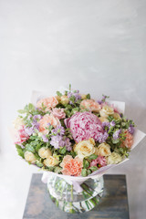 Beautiful spring bouquet. Arrangement with mix flowers. The concept of a flower shop, a small family business. Color light pink and lilac.