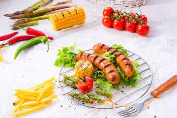 grilled krakauer sausage with boiled corn and green salad