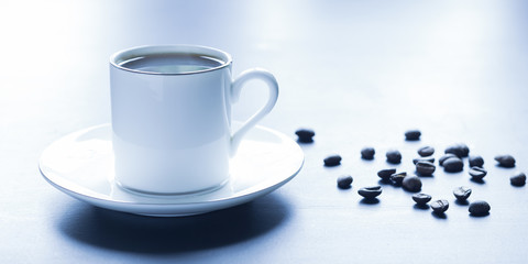 Coffee beans and a cup of fragrant coffee