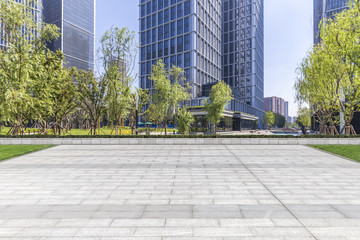 Panoramic skyline and modern business office buildings with empty road,empty concrete square floor - obrazy, fototapety, plakaty