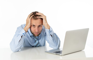 Business, people, deadline and technology concept - stressed entrepreneur businessman with laptop computer at office feeling angry and desperate.