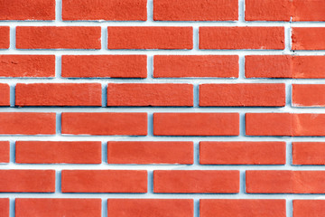 Obraz premium Brick wall of terracotta with pink tint. Bright background.