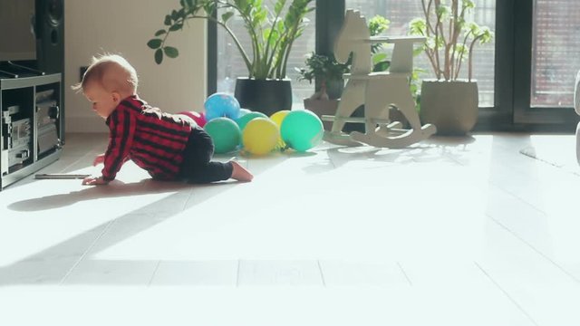 Little baby boy with crawling on the floor at home
