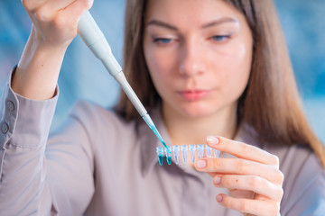 Young woman cutting of sample from pcr microtube rack