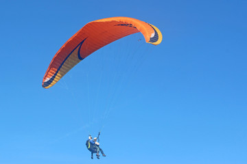 Tandem paraglider flying