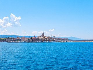 View of the city of Alghero. Shot from the sea. Sardinia, Italy.