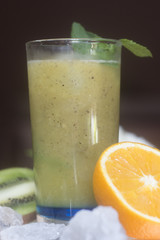 Healthy green smoothie with kiwi and oranges