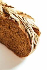 A piece of handmade freshly baked rye bread, isolated on white background.
