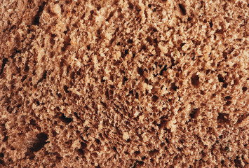 A piece of handmade freshly baked rye bread, texture background, closeup.