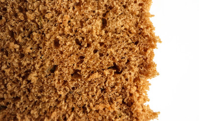 A piece of handmade freshly baked rye bread, texture background, closeup.