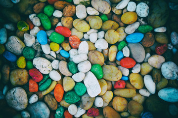 Fototapeta na wymiar Colorful pebbles background or colored gravel background