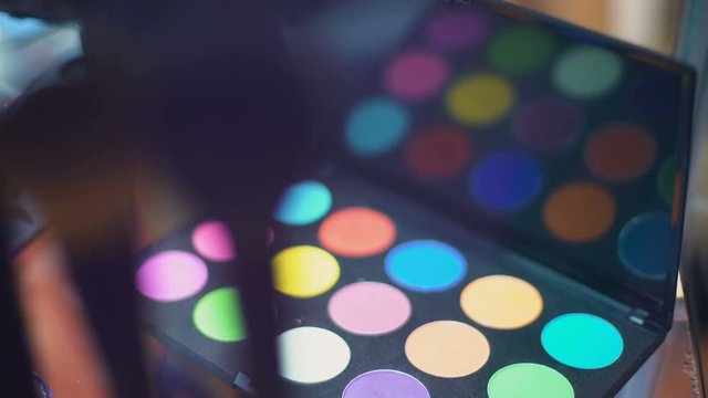 Eye shadow palette on visagist worklpace cosmetics exhibition, beauty fashion
