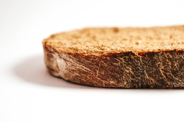 A piece of handmade freshly baked rye bread, isolated on white background.