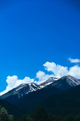Fototapeta na wymiar Beautiful alpine ice mountains peaks with snow, summer time, blue sky background.