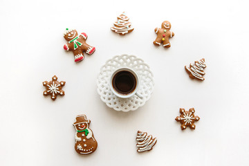 A cup of espresso or black tea on a white surface decorated in Christmas or New Year's style. Celebratory concept.