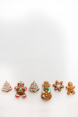 Traditional gingerbread on a white surface in a minimal style. Christmas concept. Upstairs is a place for text.