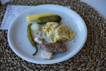 raclette dish on plate with different ingridients