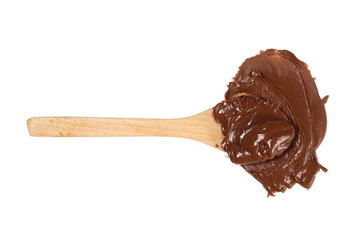Cream chocolate spreading with wooden spoon isolated on white background, top view