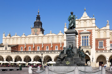 Naklejka premium Main Market Square of the old Town with Cloth Hall, Town Hall Tower, Adam Mickiewicz monument, Krakow, Poland