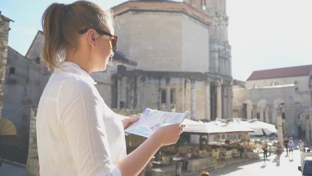 Female tourist with map visiting the city of Split.