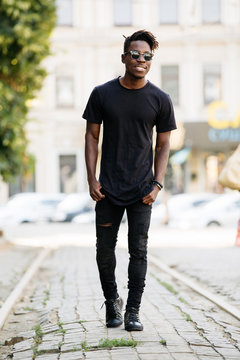 Young african man wearing black t-shirt in city street